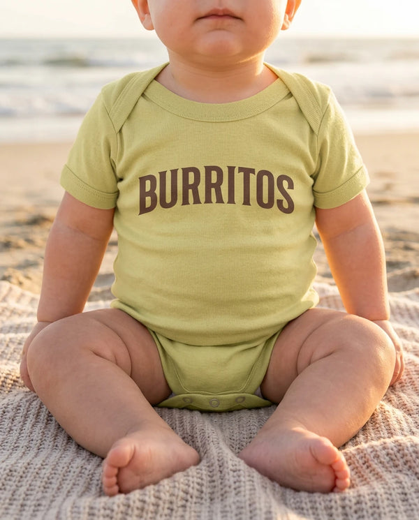Baby wearing Burritos bodysuit on a San Diego beach at golden hour