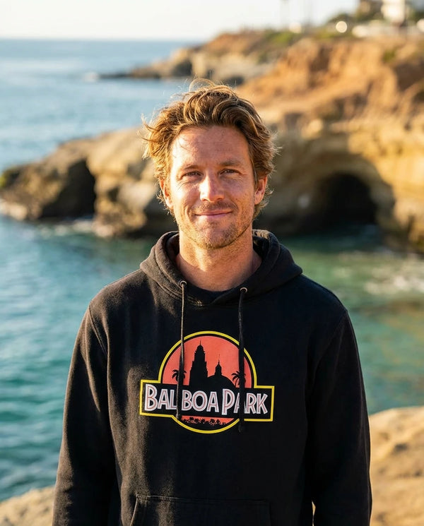 Person wearing Balboa Park Hoodie - Unisex at La Jolla Cove in San Diego