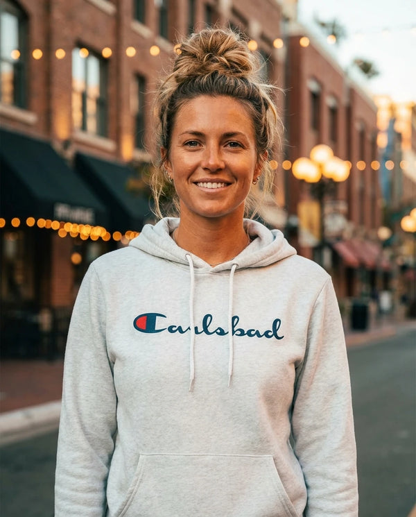 Person wearing Carlsbad (Champion Parody) Hoodie - Unisex at the Gaslamp Quarter on Fifth Avenue in San Diego