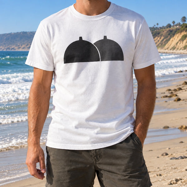 Man wearing a white T-shirt with a black twin dome San Onofre power plant silhouette on the beach